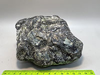 A smooth, shiney or scaly mostly blue piece of serpentinite
